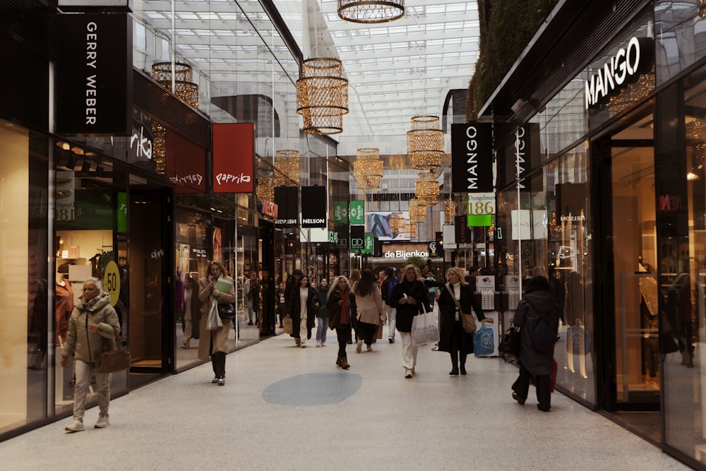 a group of people walking through a shopping mall