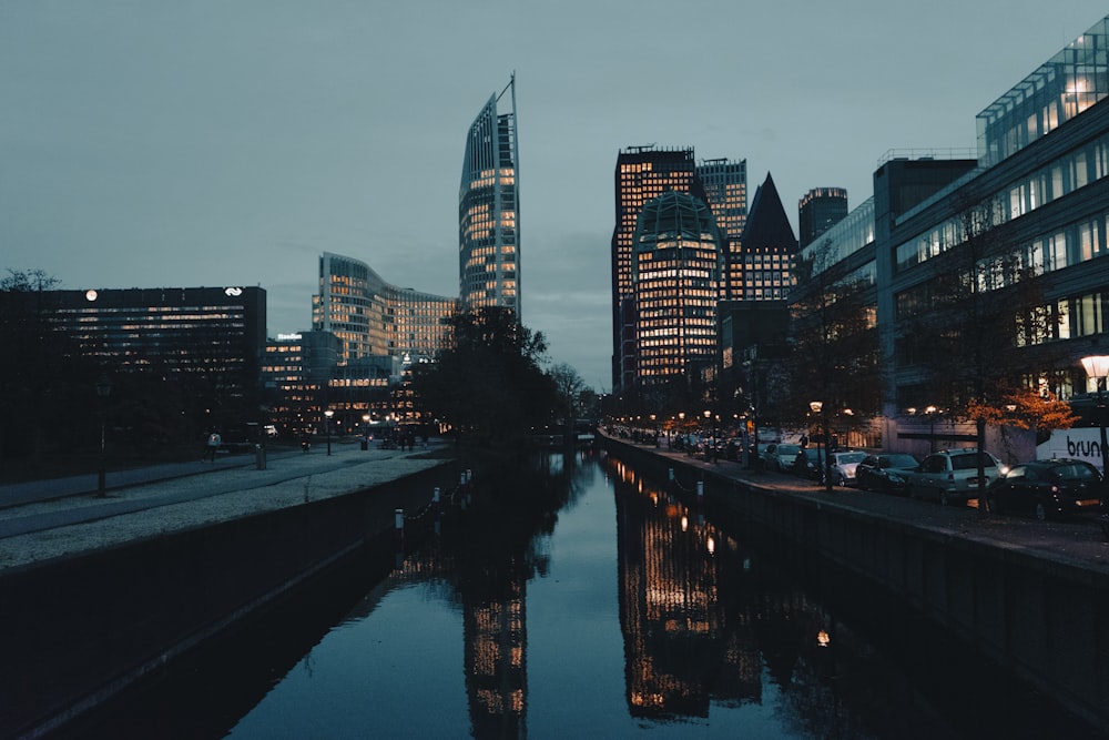 a river running through a city next to tall buildings