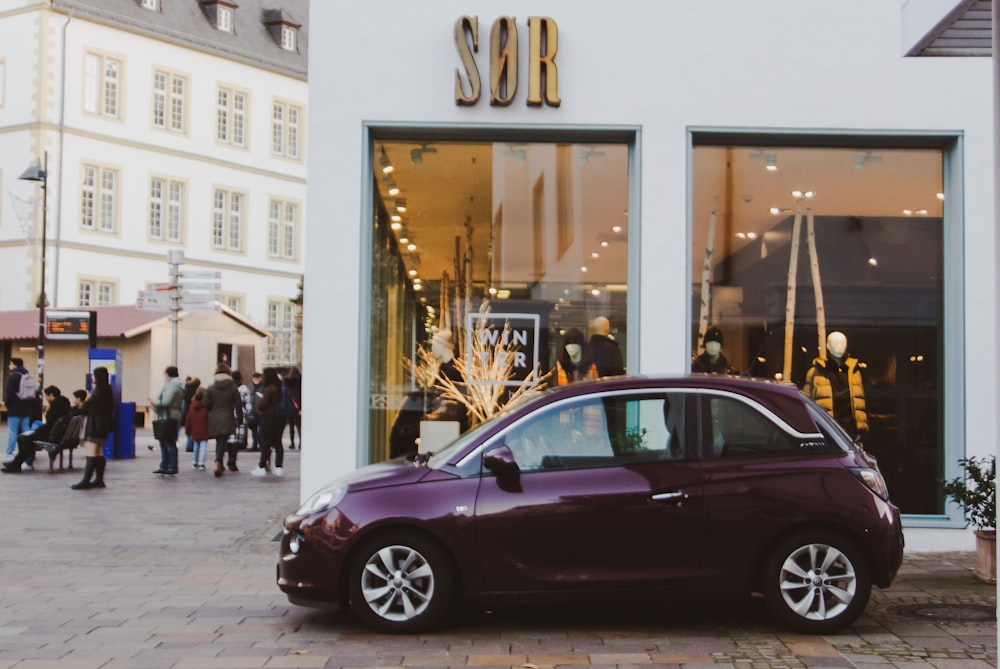 a small car parked in front of a store