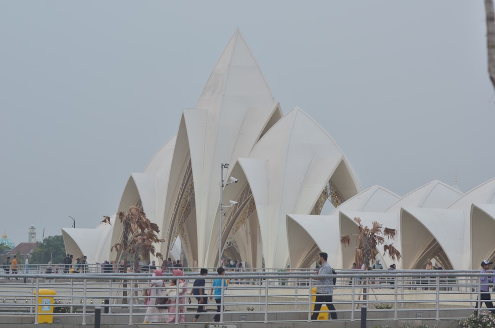 a group of people standing next to each other near a building