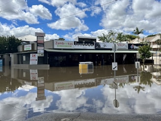 a flooded street in front of a store