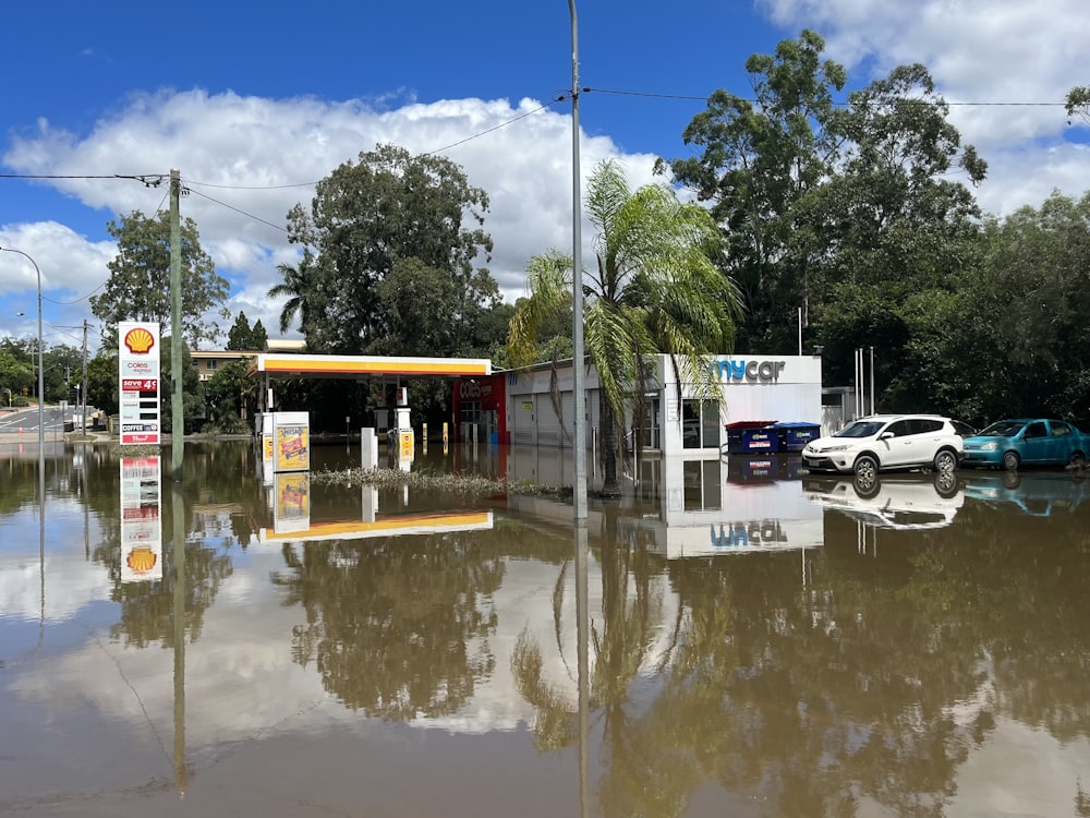 a flooded gas station with cars parked in it