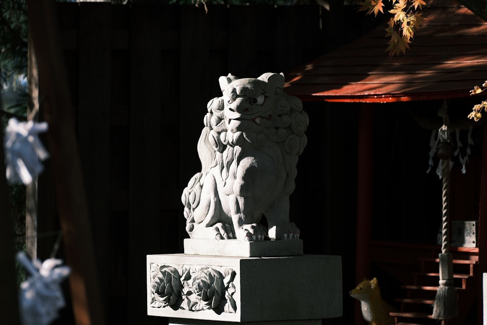 a statue of a lion on a pedestal