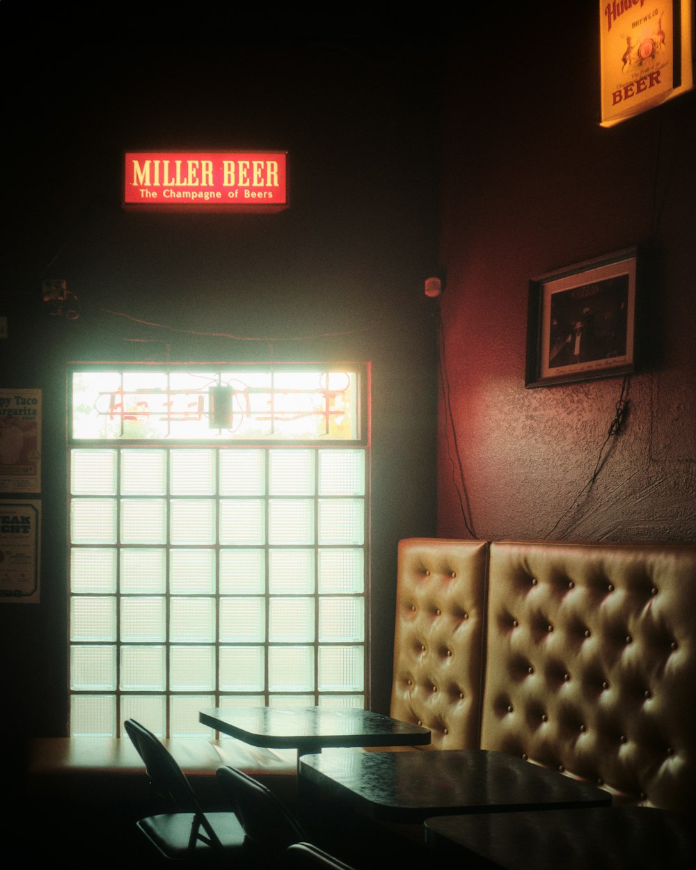 a dimly lit restaurant with a large window