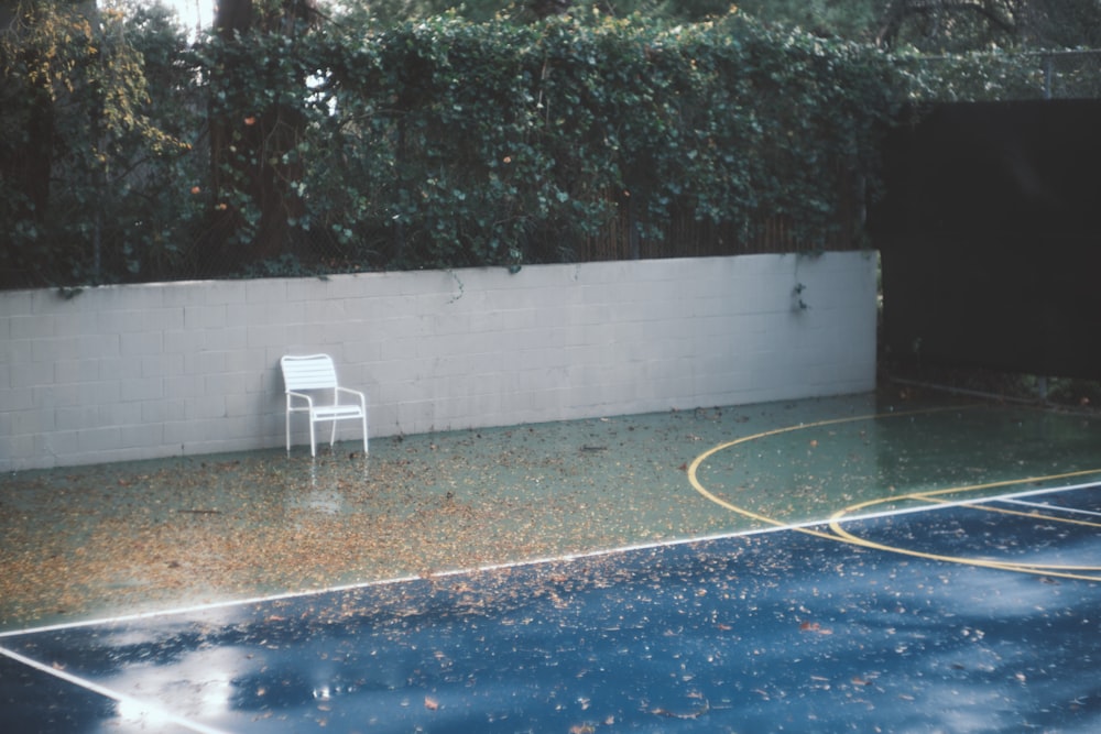 a white chair sitting on top of a basketball court