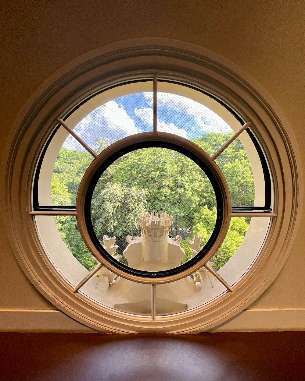 a round window with a view of a garden