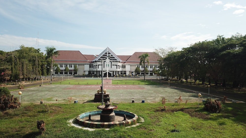 a large building with a fountain in front of it