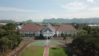 a tennis court in front of a large building