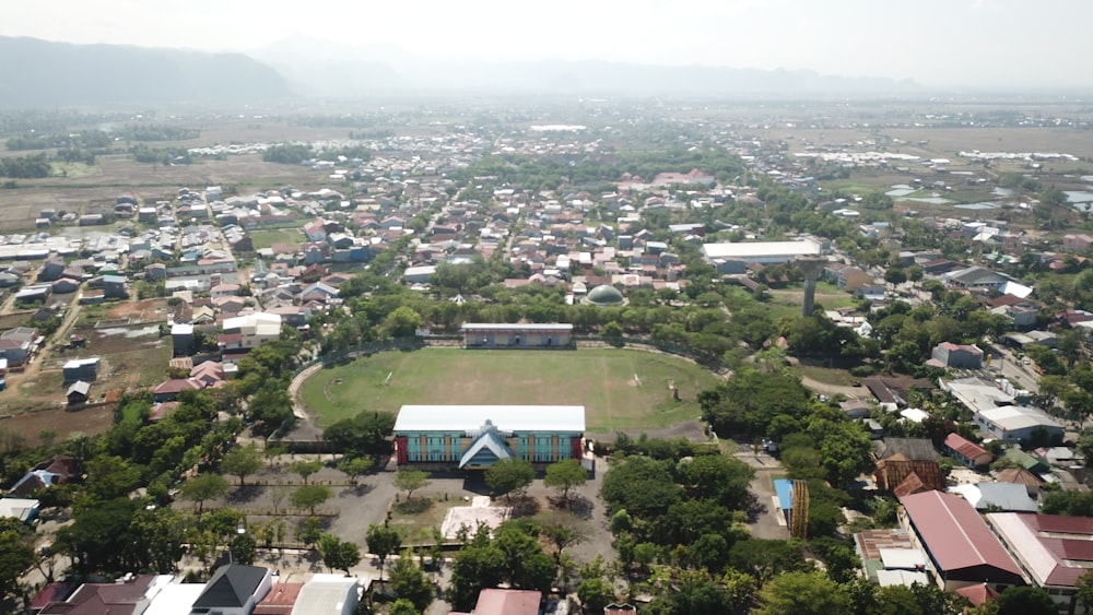 an aerial view of a small town with a soccer field