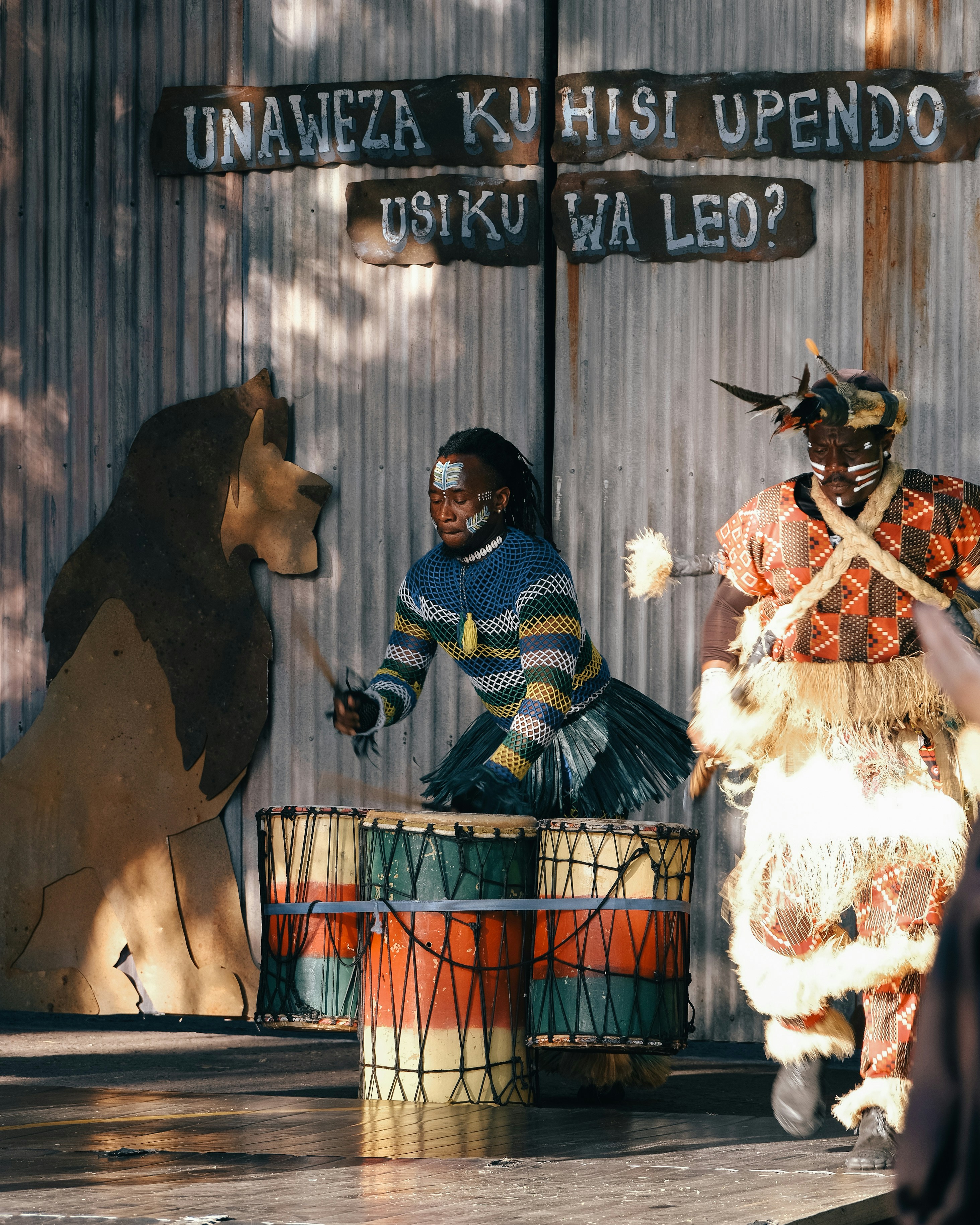 a group of people that are standing around a drum