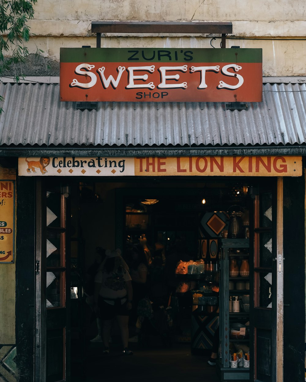 a store front with a sign that says the lion king