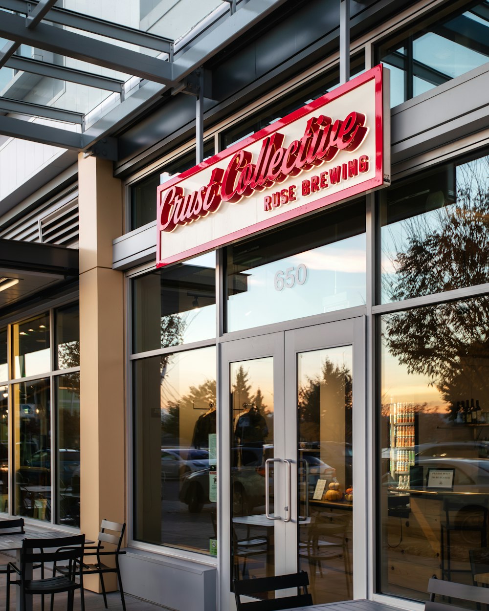 a restaurant with tables and chairs outside of it