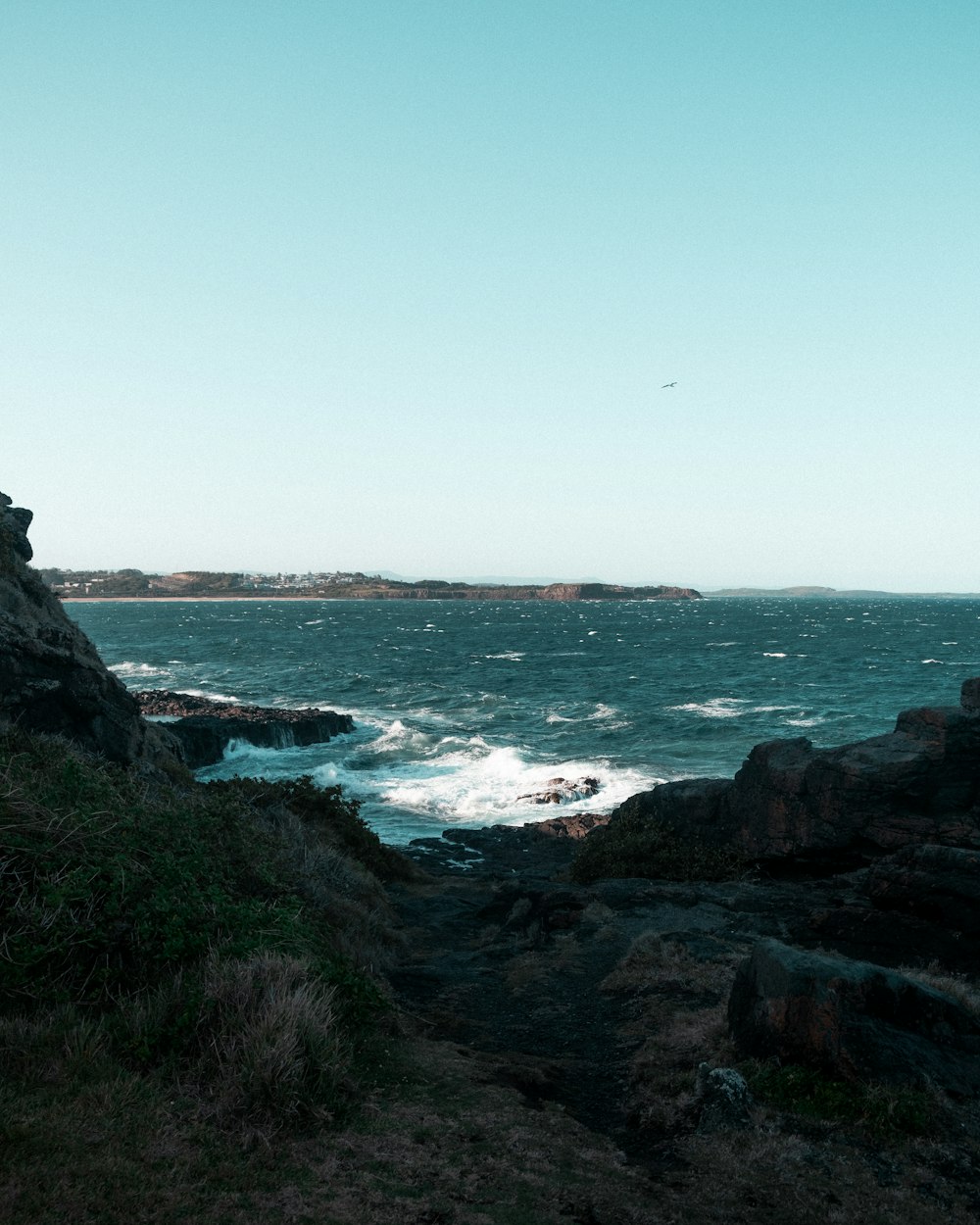 a person standing on a cliff overlooking the ocean