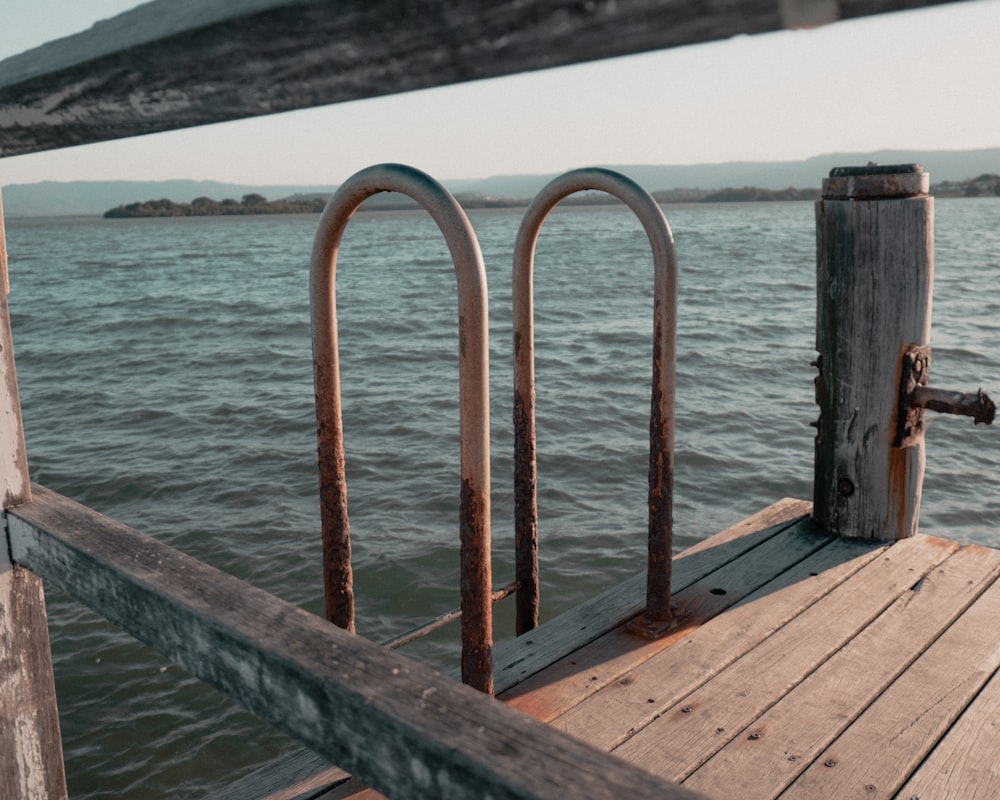 a wooden dock with two metal bars on it