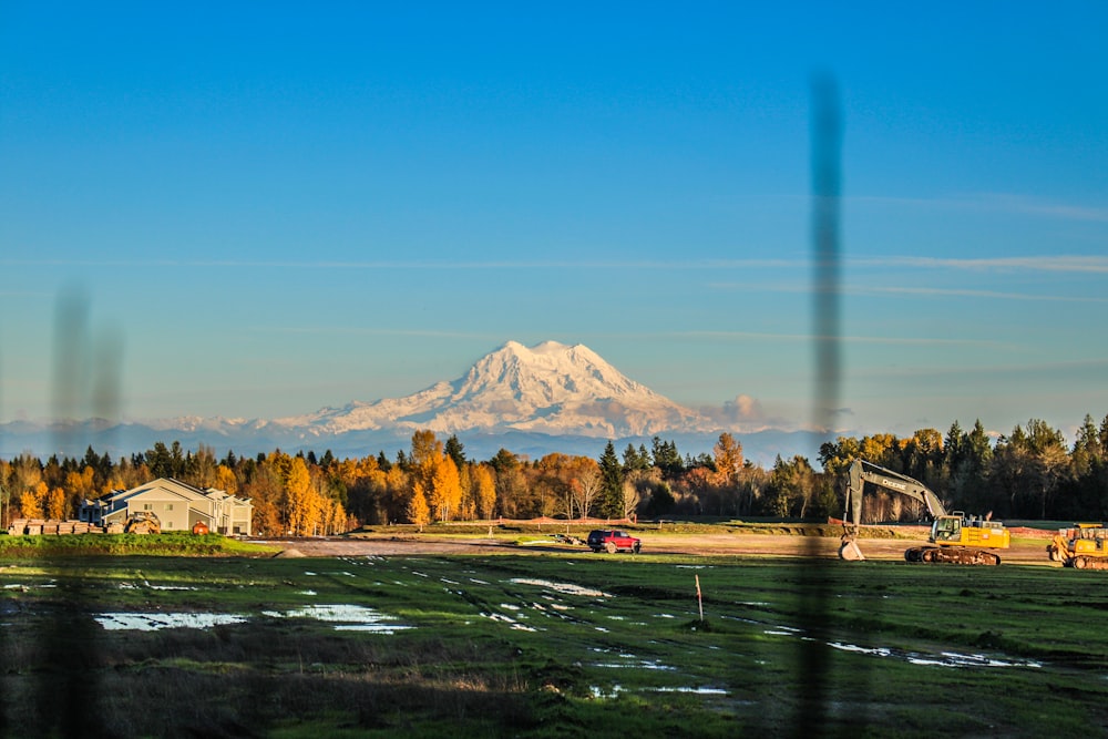 a view of a snow covered mountain from a field