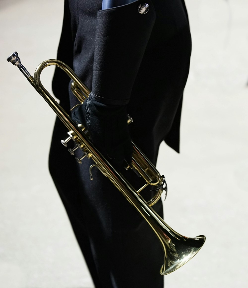 a man in a suit and tie holding a trumpet