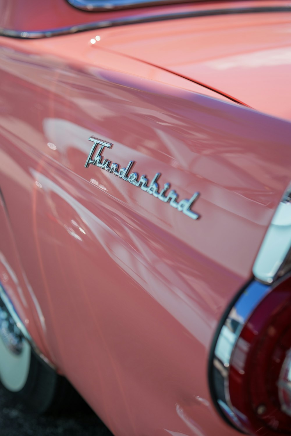 a close up of the tail end of a pink car