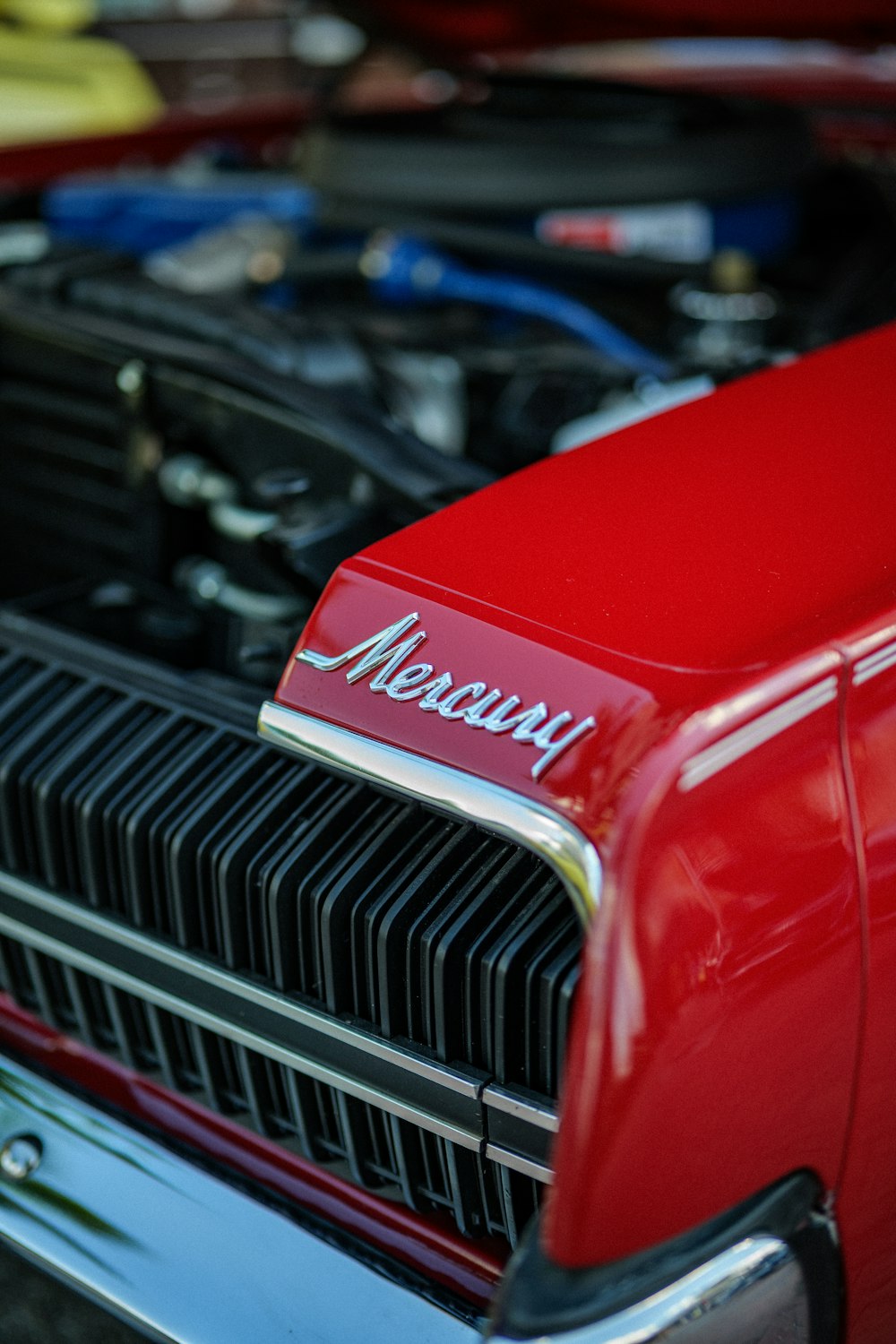 a close up of the hood of a red car