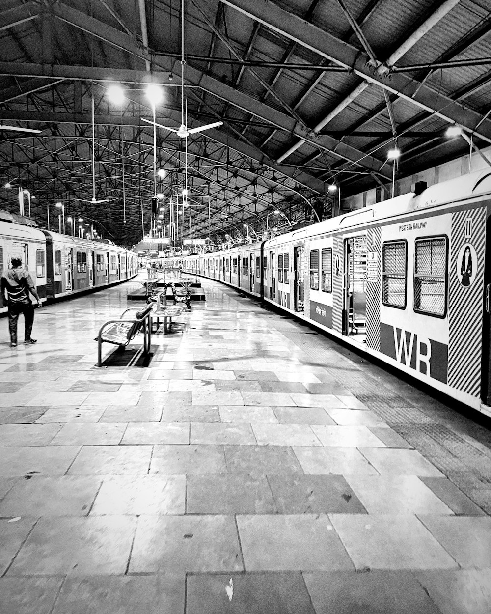 a couple of trains parked next to each other in a train station