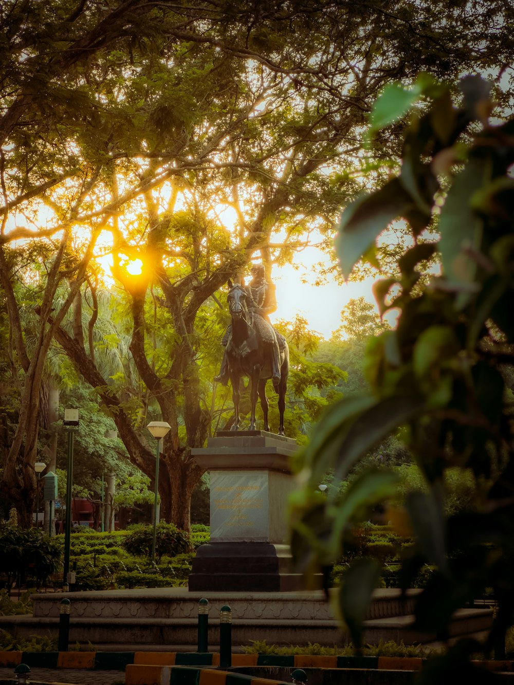 a statue of a man riding a horse in a park