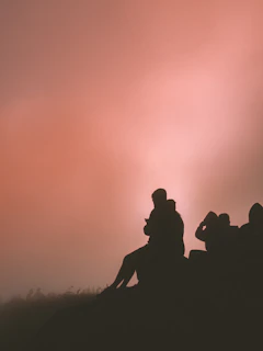 A peaceful meditation circle at sunset on a hilltop overlooking rolling hills.