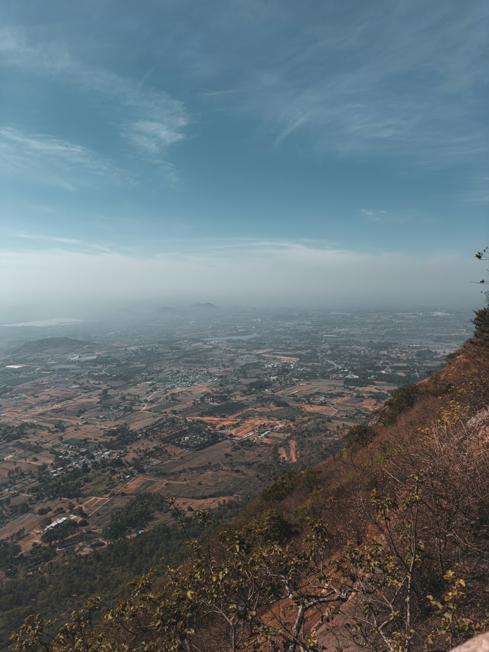 a person sitting on a hill overlooking a valley