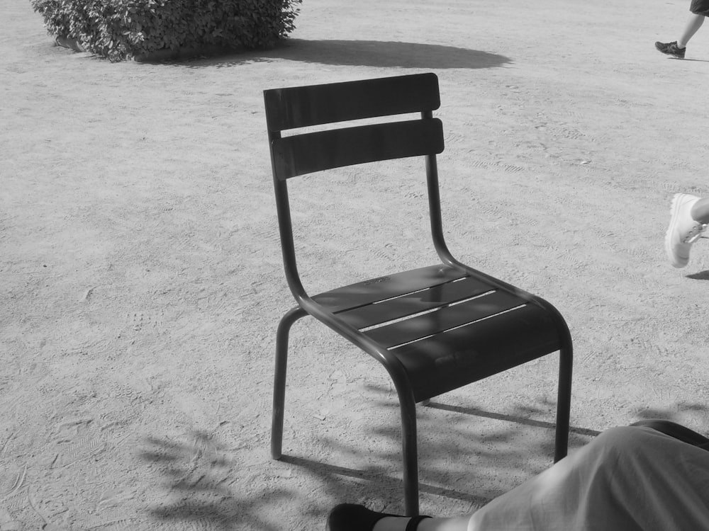 a black and white photo of a chair and a person