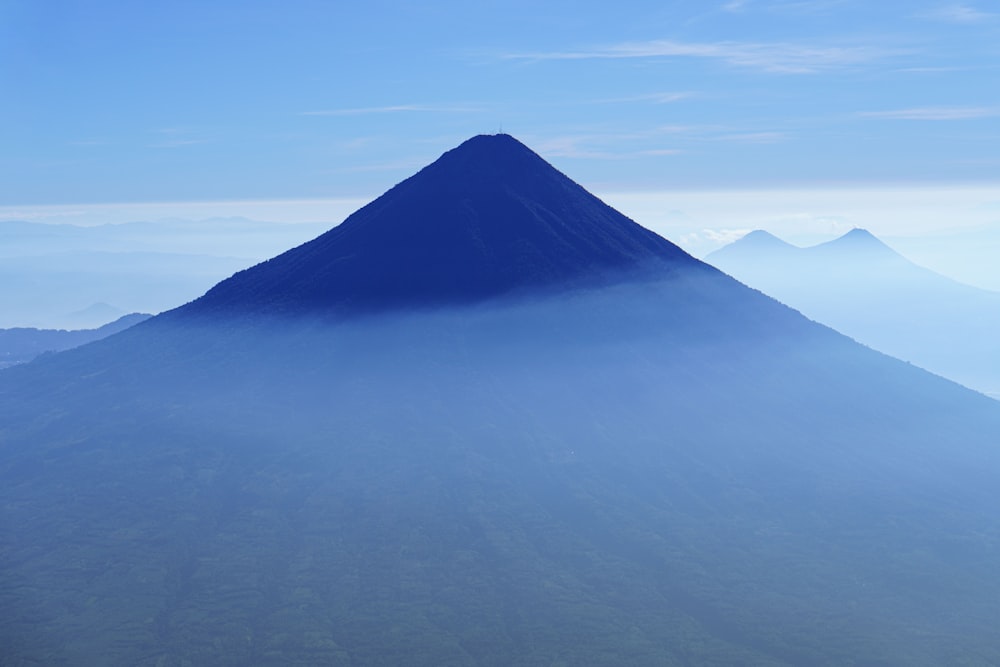 a very tall mountain with a very blue sky