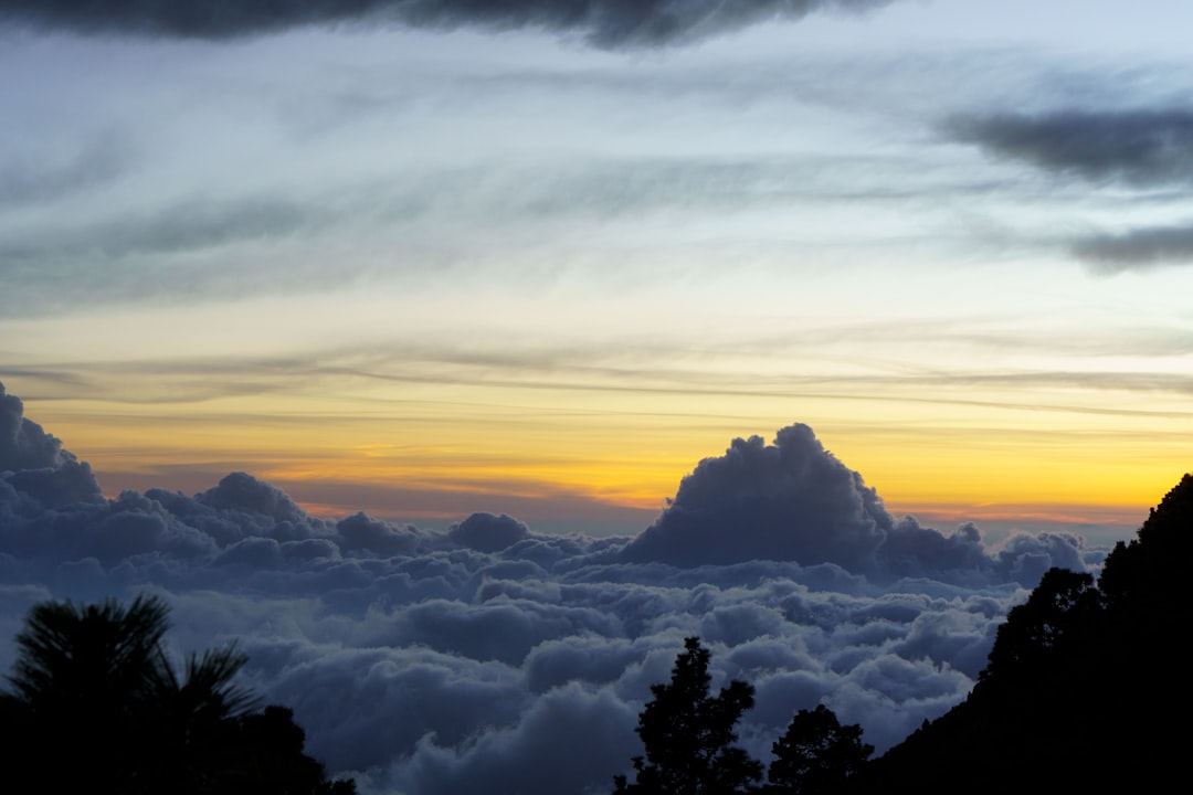 the sun is setting over the clouds in the sky, Nature scenery from the Acatenango Volcano, in Alotenango, Guatemala.