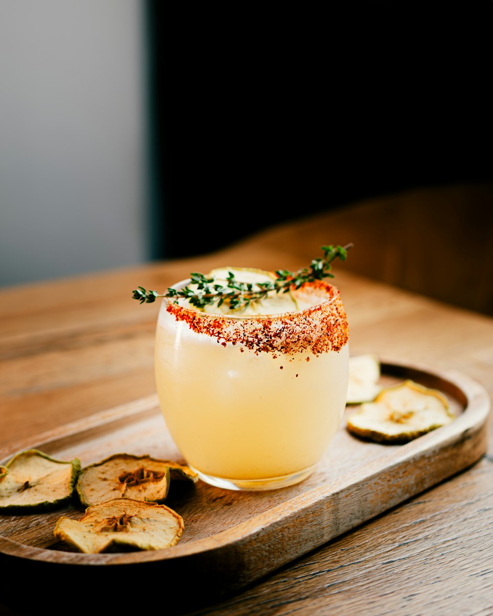 a glass of wine with a garnish garnish on top of it