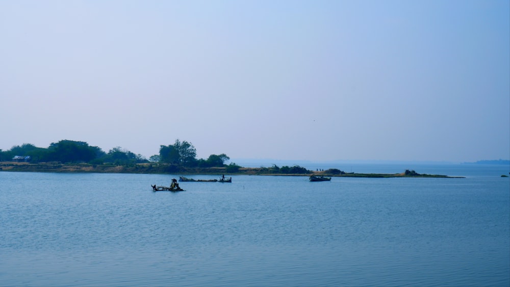 a group of boats floating on top of a large body of water