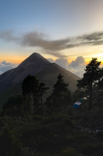 Sunrise over Acatenango volcano with hikers setting up camp