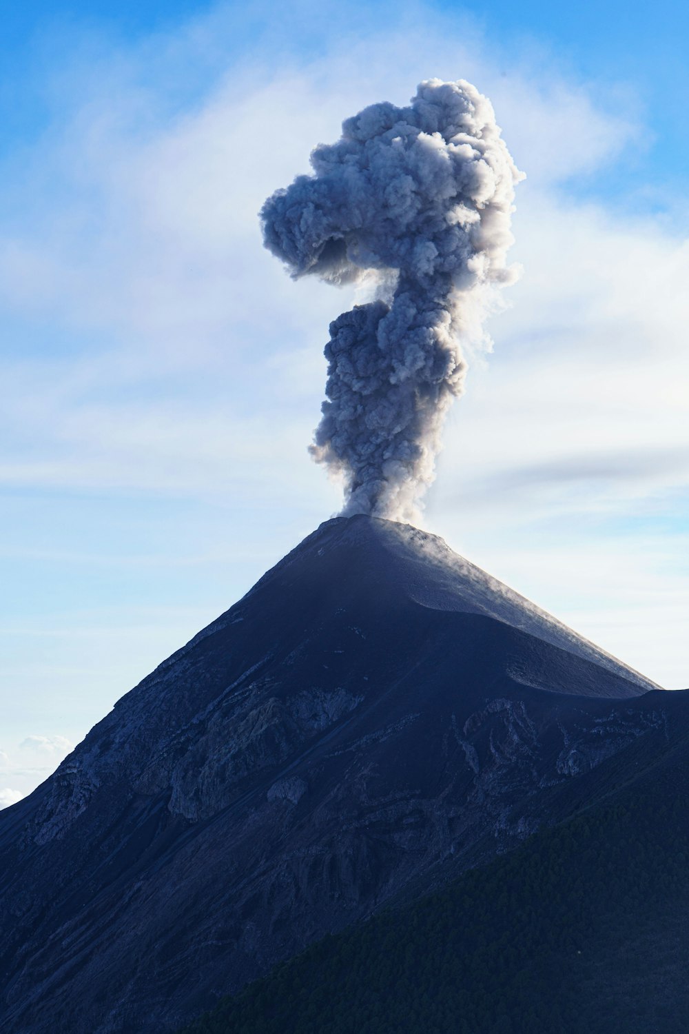 a large plume of smoke coming out of the top of a mountain