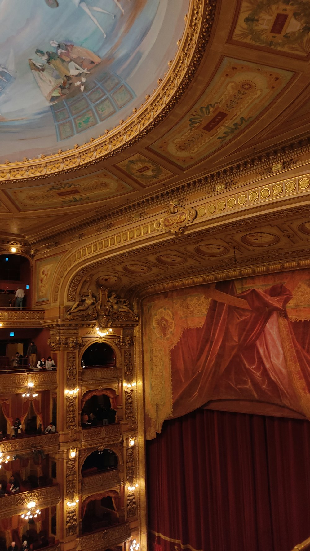 a view of a theater stage with a painted ceiling