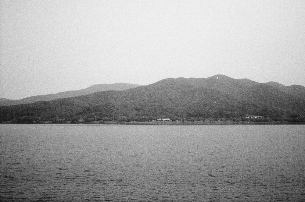 a large body of water with mountains in the background