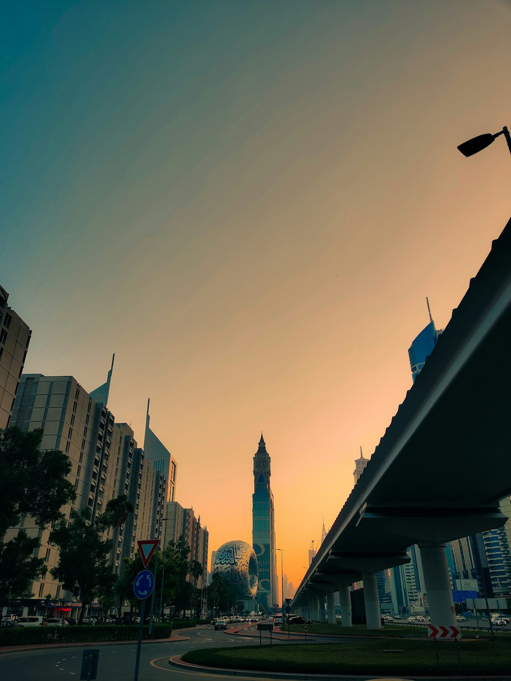 a city street with a clock tower in the background