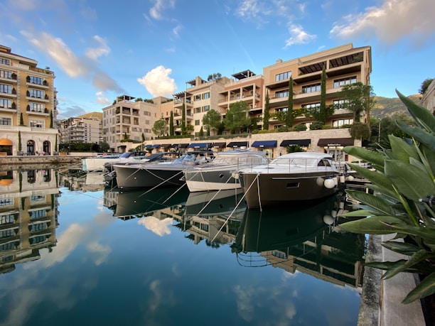 A serene marina scene with luxury yachts docked under clear skies, symbolizing premium nautical lifestyle.
