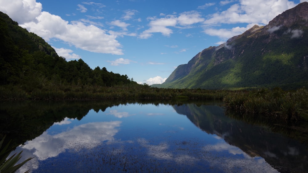 a body of water with mountains in the background