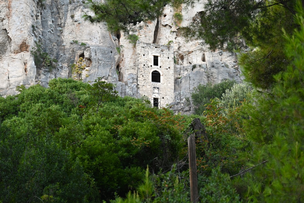 a rock face with a small window in the middle of it