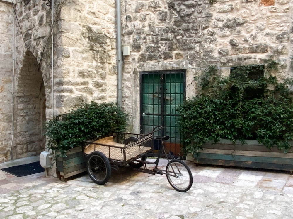 a bike parked next to a stone building