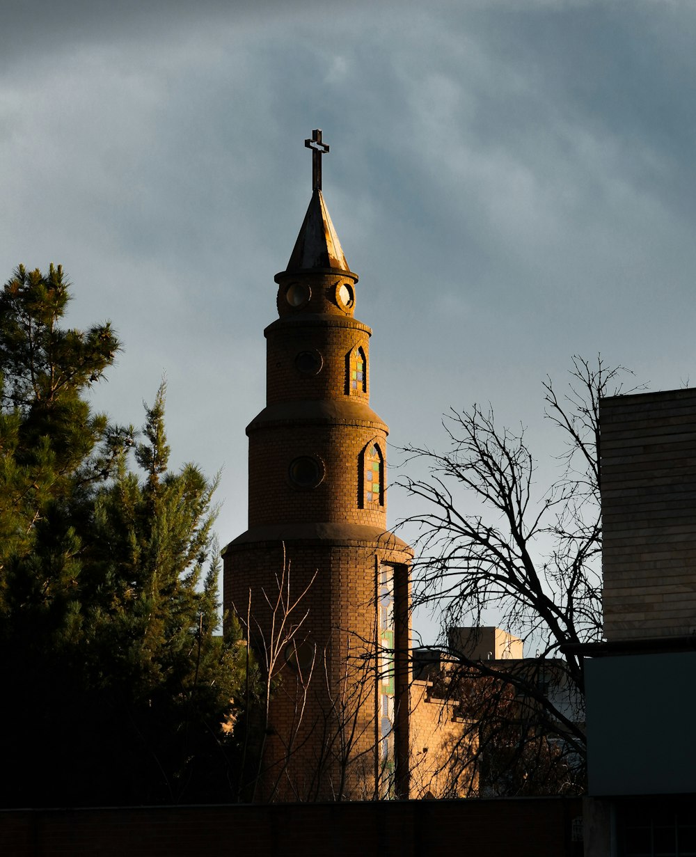 a tall tower with a cross on top of it