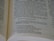 An open book featuring a section of text that appears to be a passage from a religious or biblical text, printed in a clear, serif font on off-white paper. The pages are slightly curved, suggesting that the book is laid open flat.