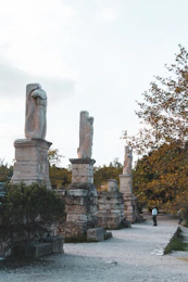 a statue of a woman and a man in a park