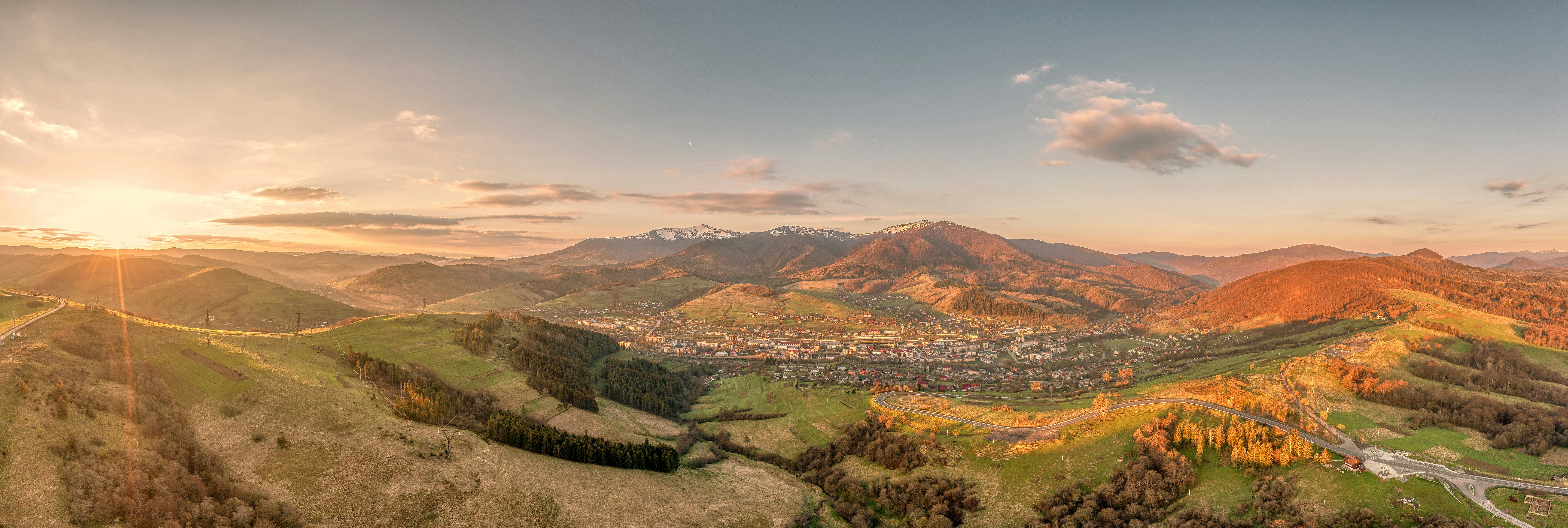 a scenic view of a city in the mountains