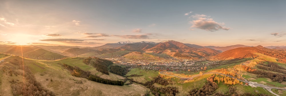 a scenic view of a city in the mountains