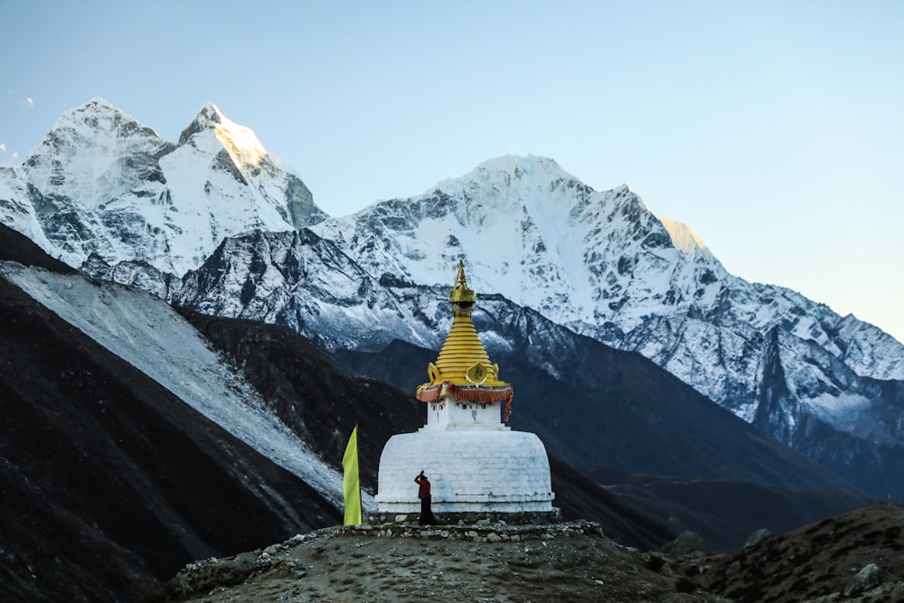 a person standing on top of a snow covered mountain