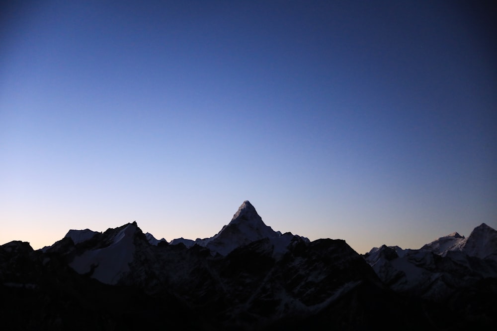 a view of the top of a mountain at dusk