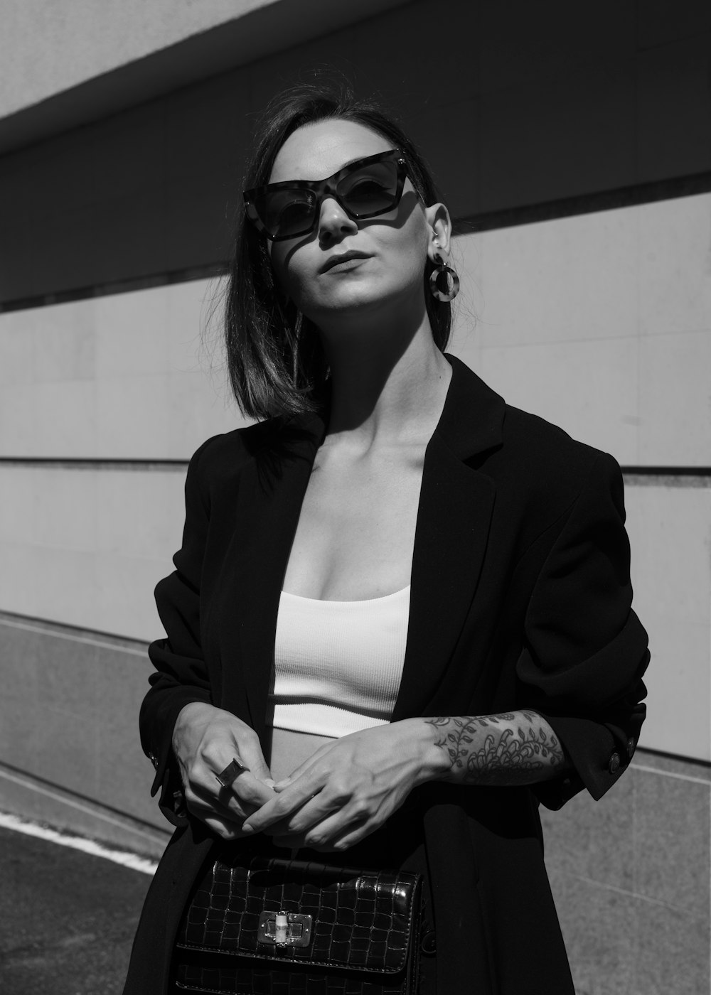 a woman wearing sunglasses and a black jacket