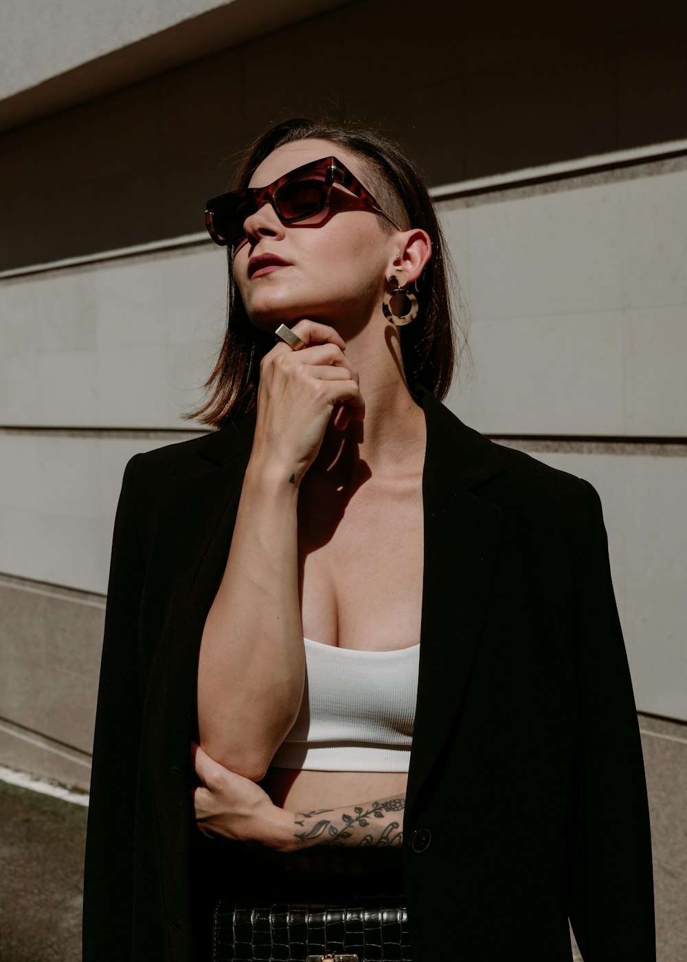 a woman in a white top and black blazer