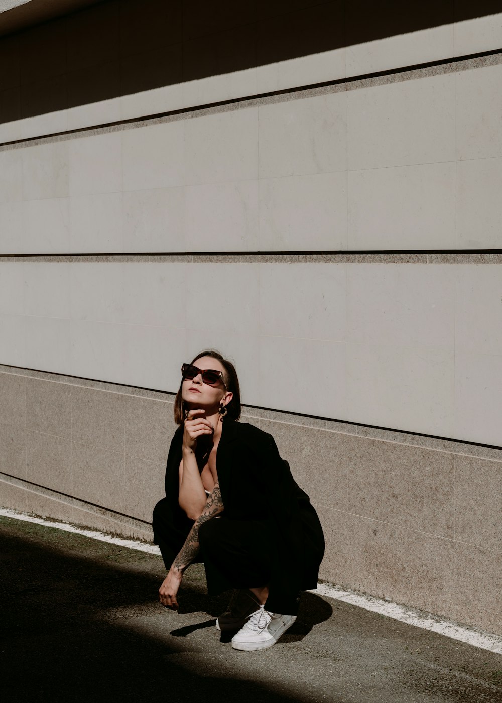 a woman sitting on the ground with her hands on her face